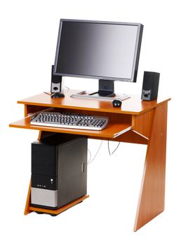 Modern personal computer on a table, isolated on white background