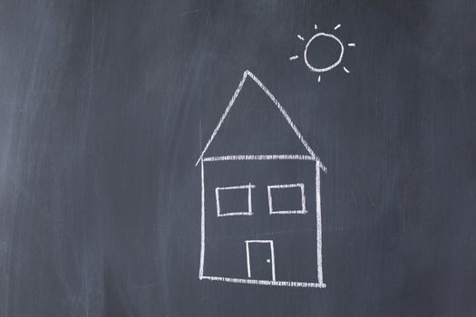 House and sun on a blackboard