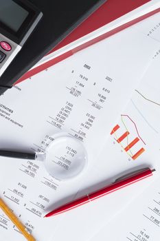 Worktable covered with financial documents, close-up photo