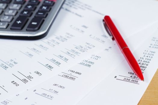 Worktable covered with financial documents, close-up photo