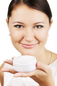 Young beautiful woman applying skin cream, isolated on white background