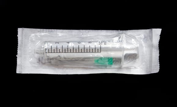 Disposable syringe isolated on black background