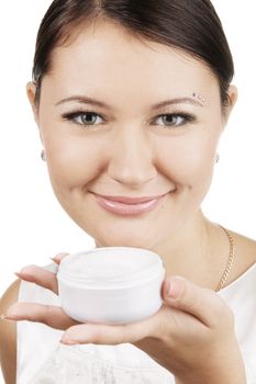 Young beautiful woman applying skin cream, isolated on white background