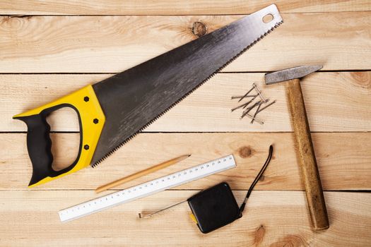 Carpenter's tools on pine desks, closeup photo