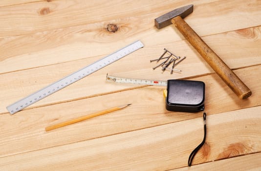 Carpenter's tools on pine desks, closeup photo