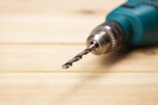 Drill on pine desks closeup photo