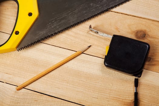 Carpenter's tools on pine desks, closeup photo