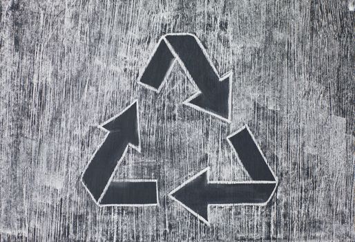 Recycle symbol on a white chalky background