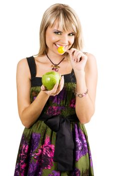 Beautiful young woman with a candy and apple, isolated on white background