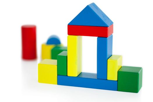 House built out of wooden toy on a white background