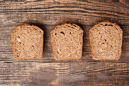 Slices of brown bread on a wooden table