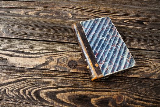 Aged blank book on wooden table