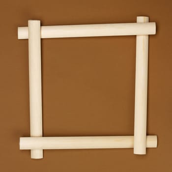 Wooden frame on brown paper background