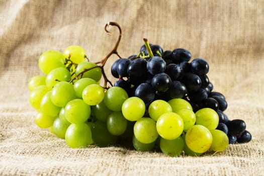 Fresh grapes on rustic vintage background, studio photo