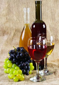 Wine and grapes on vintage background, studio photo