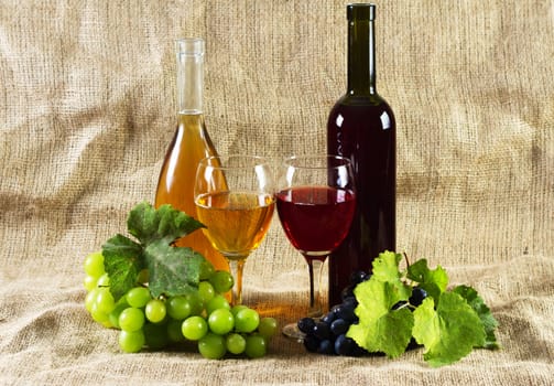 Wine and grapes on vintage background, studio photo