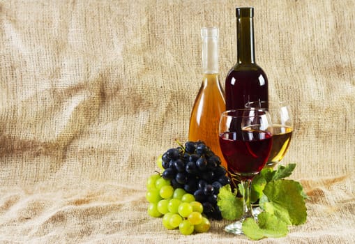 Wine and grapes on vintage background, studio photo