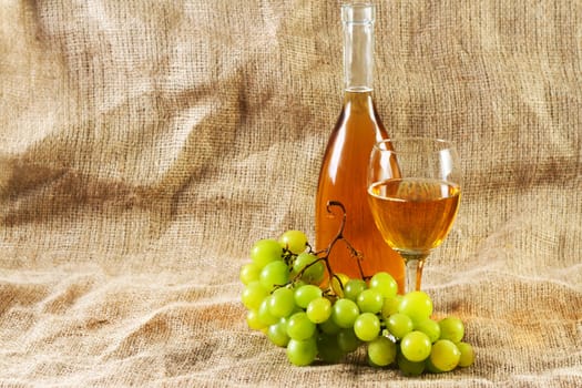 Wine and grapes on vintage background, studio photo