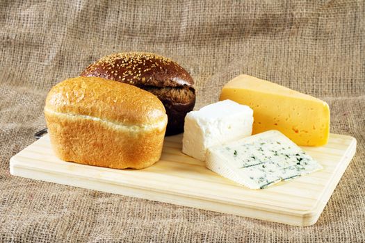 Bread and cheese on cloth background, studio photo