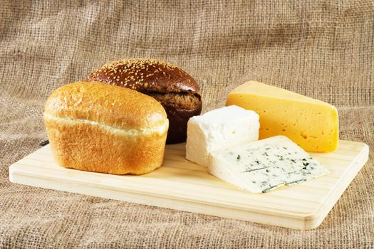 Bread and cheese on cloth background, studio photo