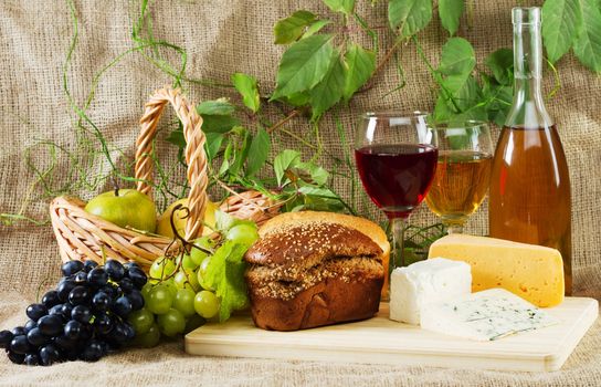 Wine and grapes on vintage background, studio photo