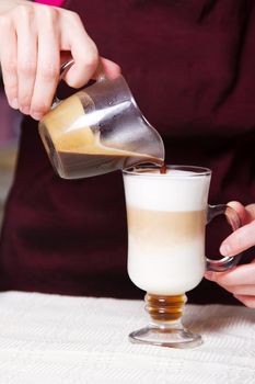 Barista making latte, closeup photo