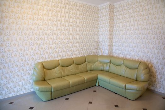 Green sofa in a room corner