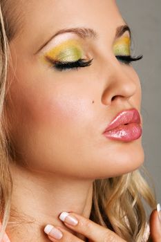 Fashionable young woman with vibrant makeup, face portrait