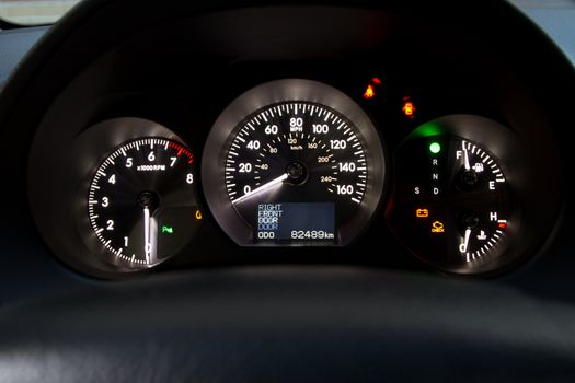 Illuminated sports car dashboard closeup photo