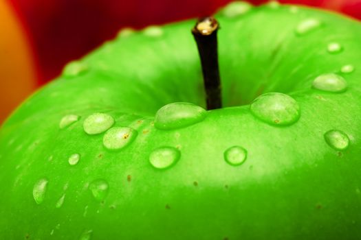 Green apple with waterdrops on its surface