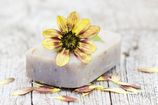 bar of natural soap and flower