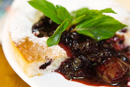 Closeup shot of a pie with strawberry jam and mint leaves