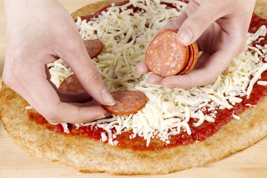 Making a pepperoni pizza using a human hand