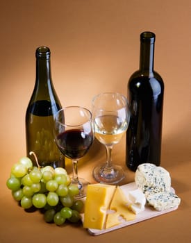 Wine, grapes and different  kinds of cheese still-life