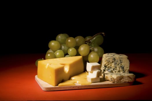 Wine, grapes and different  kinds of cheese still-life