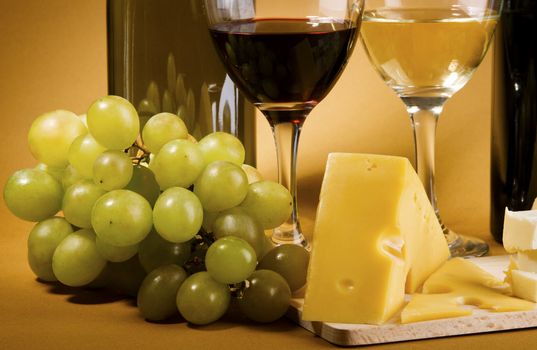 Wine, grapes and different  kinds of cheese still-life