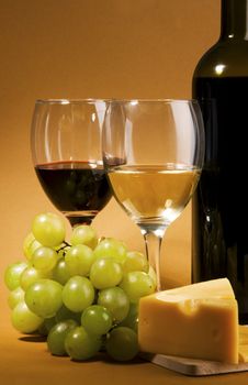 Wine, grapes and different  kinds of cheese still-life