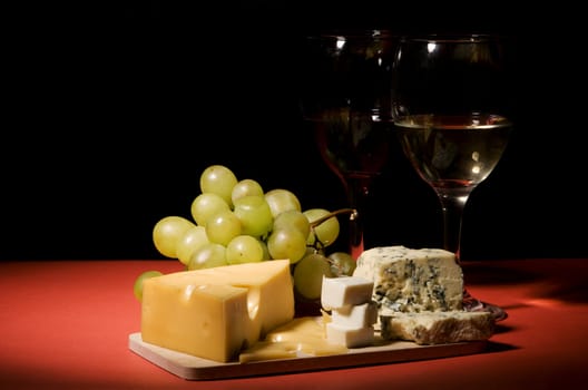 Wine, grapes and different  kinds of cheese still-life