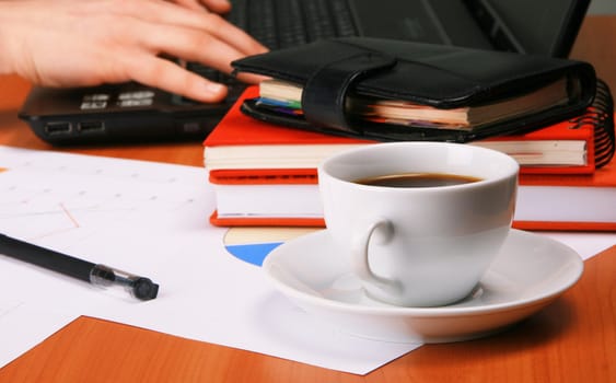 Businessman's workplace with documents and cup of coffee