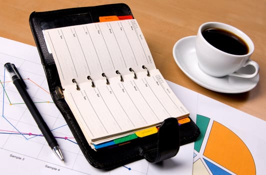 Businessman's workplace with documents and a notebook