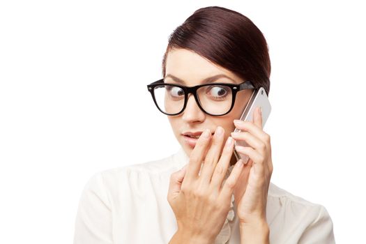 Strict woman in large glasses with a cell phone, isolated on white background