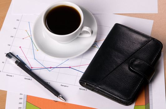 Worktable covered with documents, with a cup of coffee