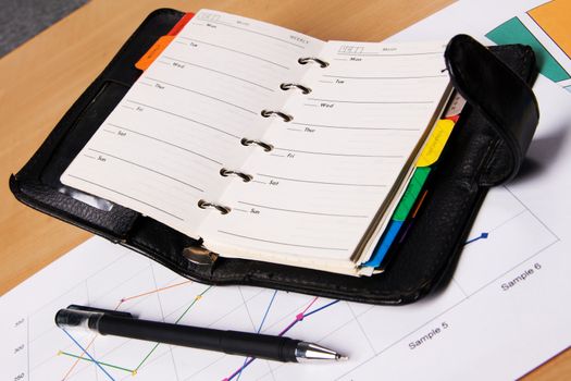 Businessman's workplace with documents and a notebook