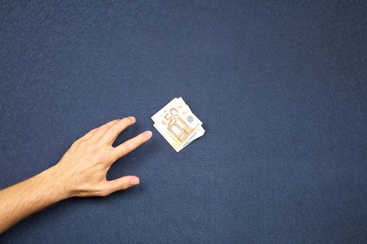 hand of man and wad of euros on white background