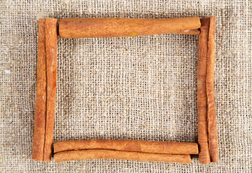 Cinnamon sticks frame on a sacking cloth
