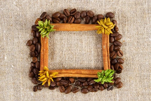 Cinnamon and coffee frame on a sacking cloth