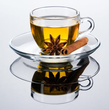 Tea cup with spice, closeup photo on gray background