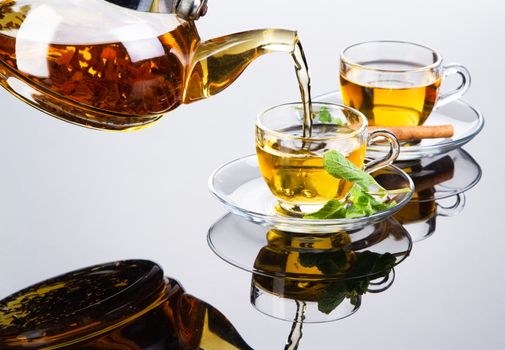 Tea cup with fresh mint leaves, closeup photo