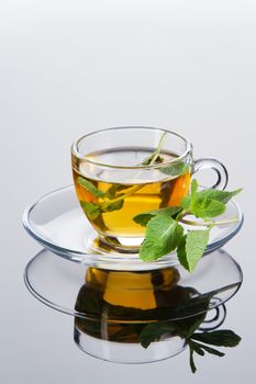 Tea cup with fresh mint leaves, closeup photo