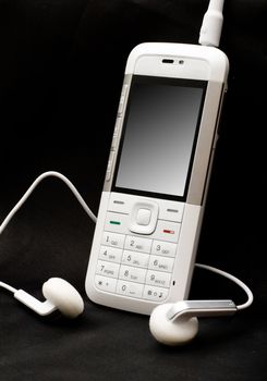 White mobile phone on black background